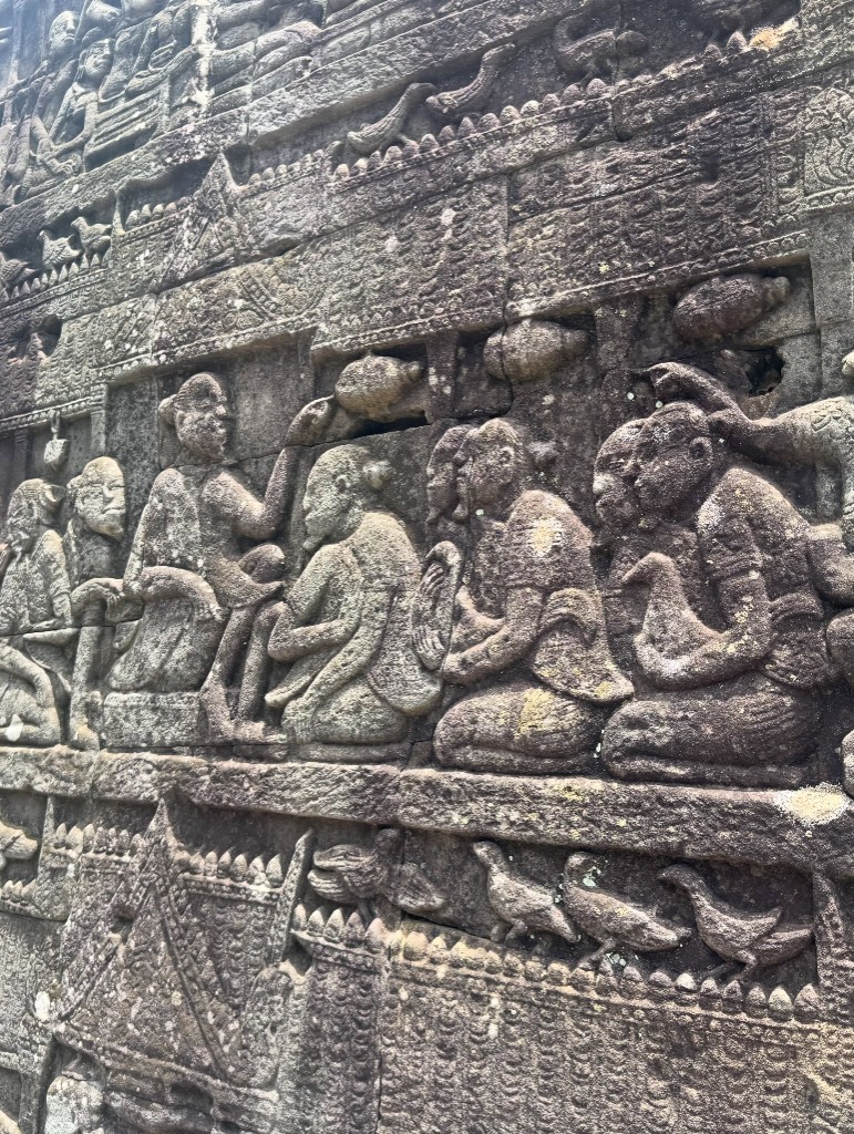 A carved procession of seated figures with a row of birds along the base of the panel